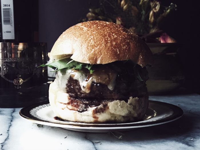 A ground beef cheesy Italian burger recipe with parmesan cheese and red wine sauce. Get this and more delicious Italian recipes on GP. #italianrecipes