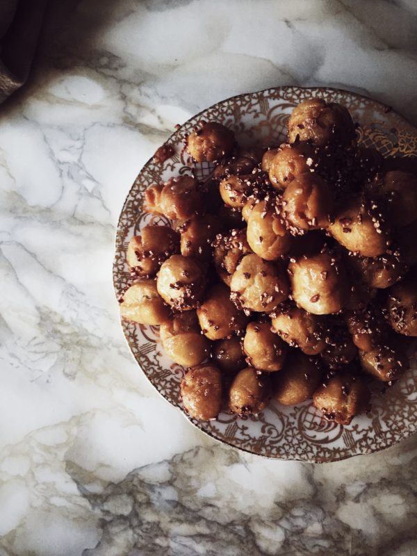 the italian struffoli recipe: tiny dough balls, fried and dipped in honey, lastly sprinkled with colorful confetti