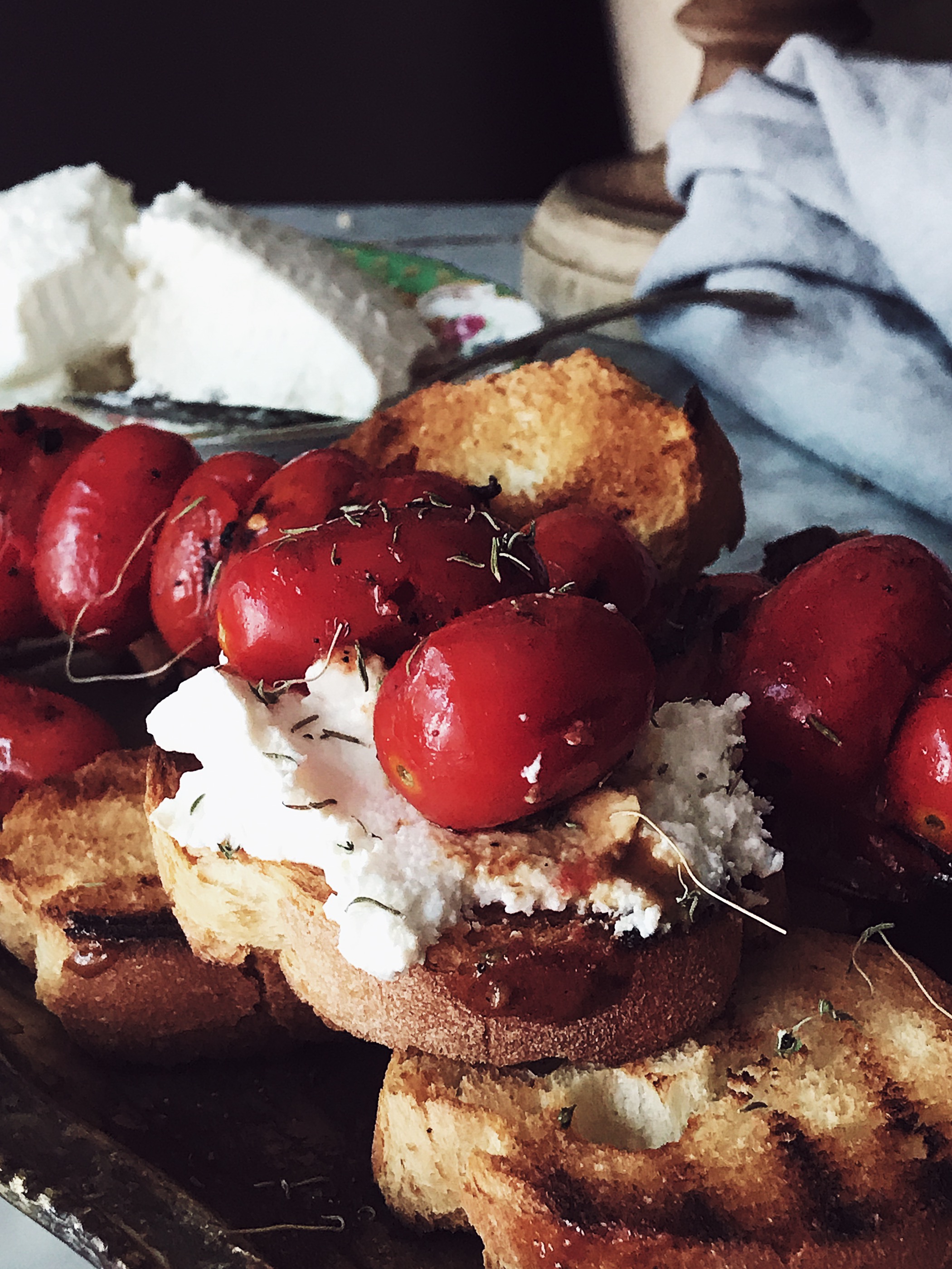 ricotta bruschetta with grilled cherry tomatoes skewers on an antique tray