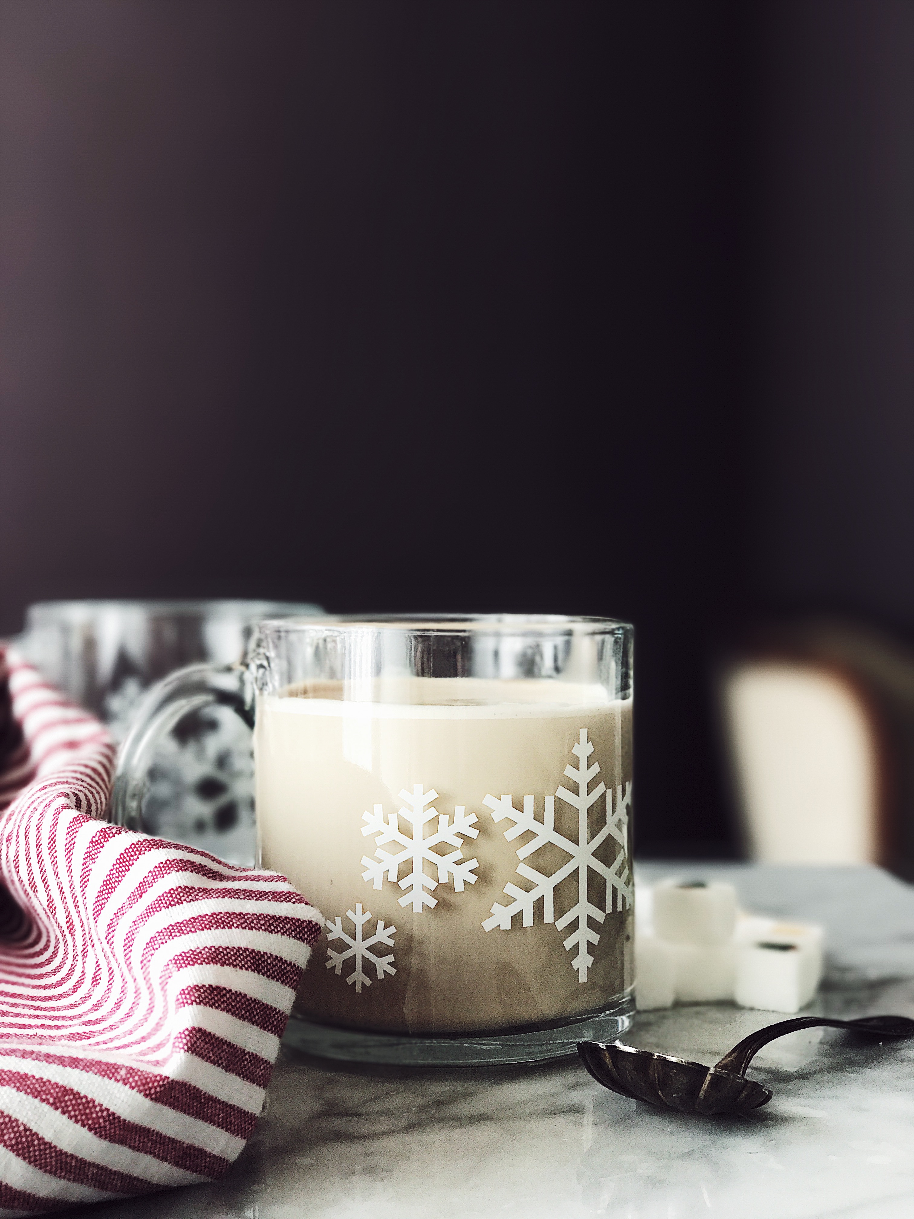 latte macchiato recipe served in a glass cup with snowflakes decor