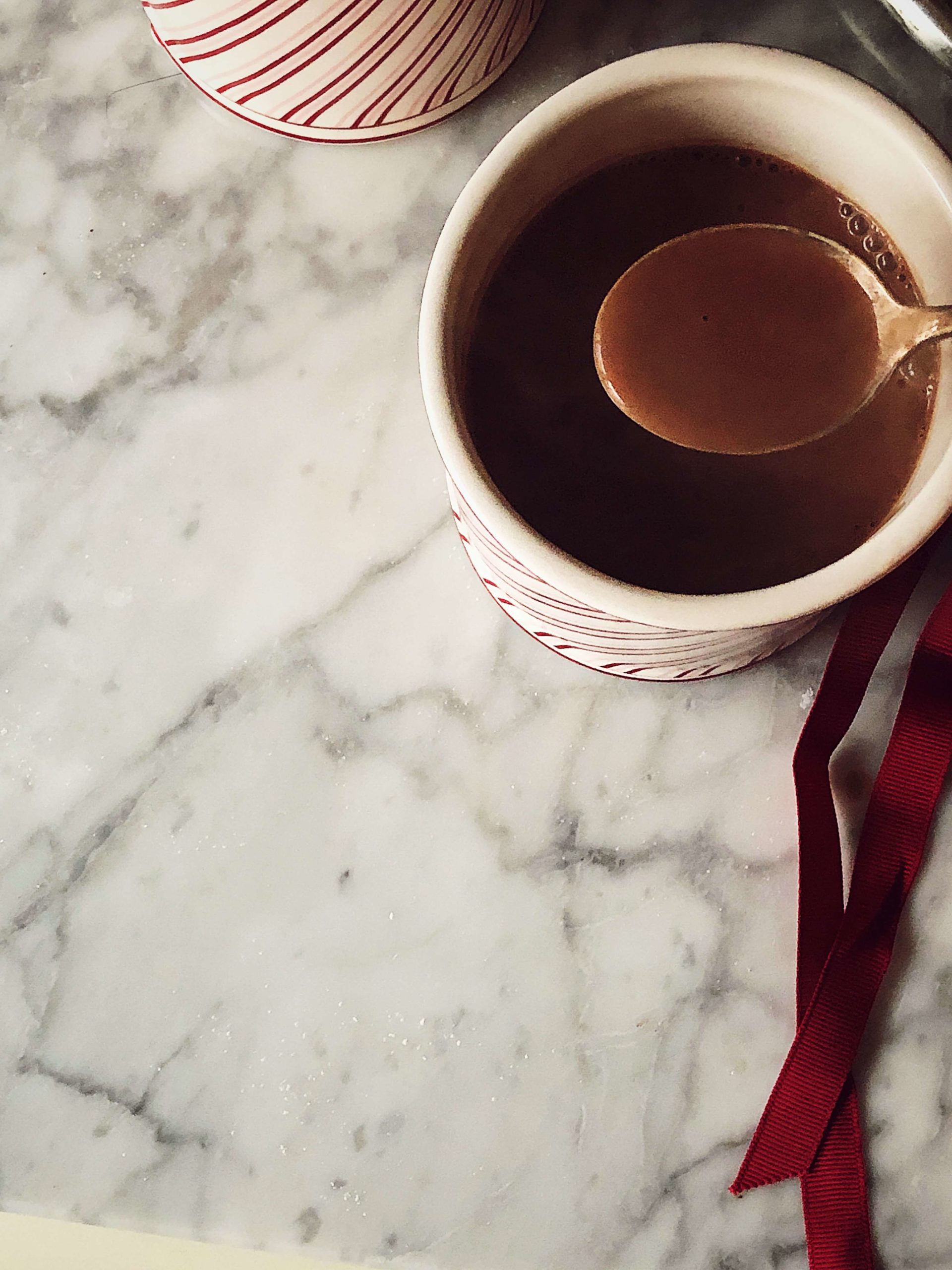 Hot chocolate with nutmeg and honey in a red and white cup