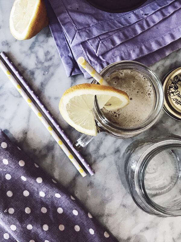 shandy beer recipe served in glass jars with a slice of lemon