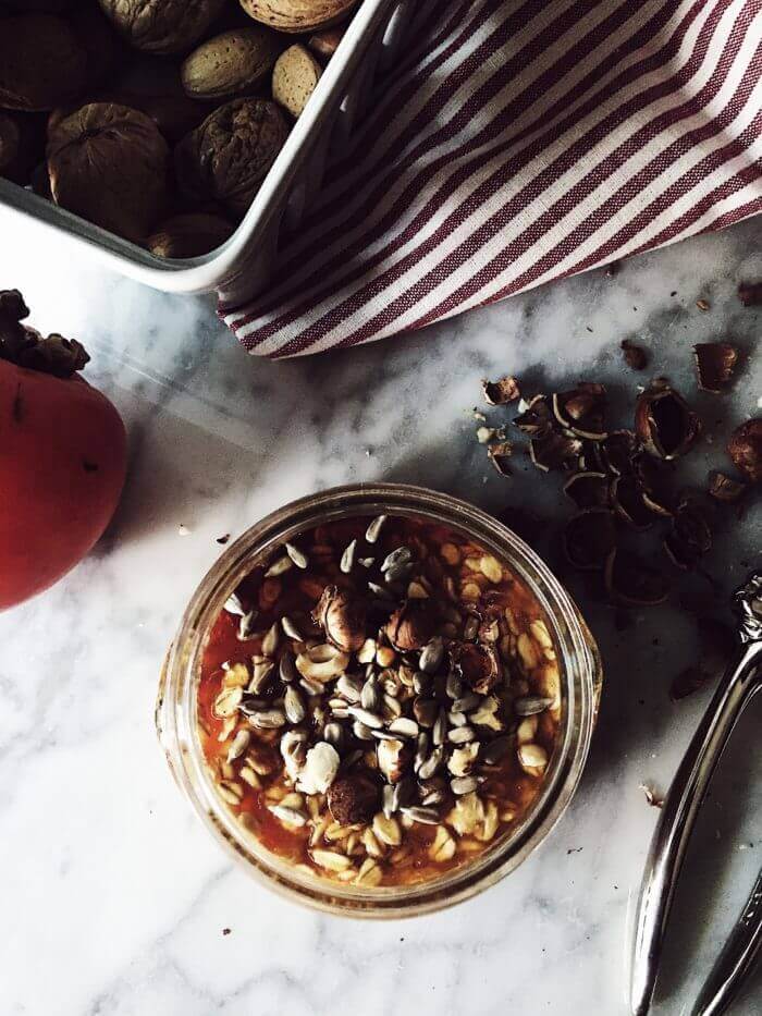 Overnight oats in a jar with persimmon fruits
