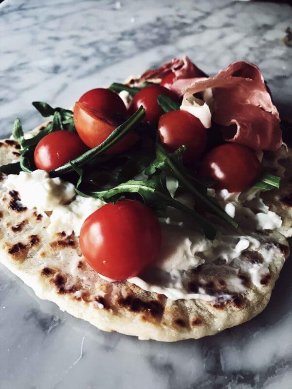 piadina with arugula, tomatoes, and stracchino cheese