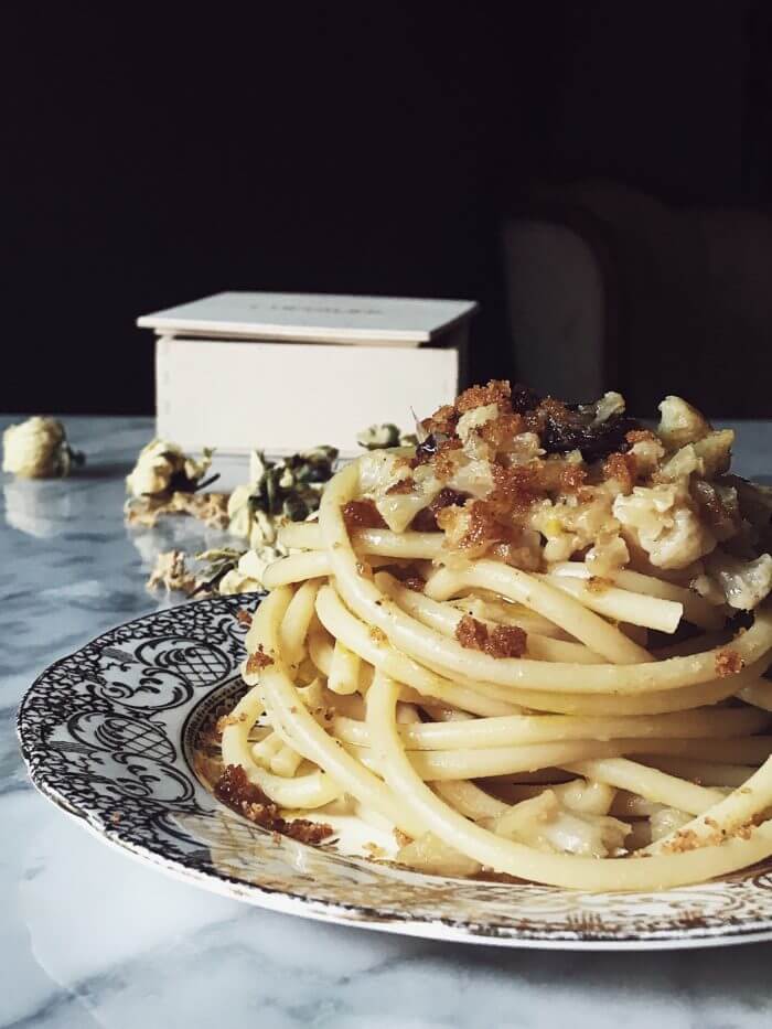 Italian cauliflower pasta recipe on a golden plate