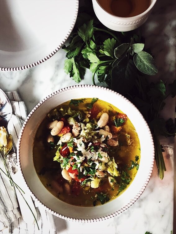 minestrone soup recipe garnished with parmesan cheese and parsley