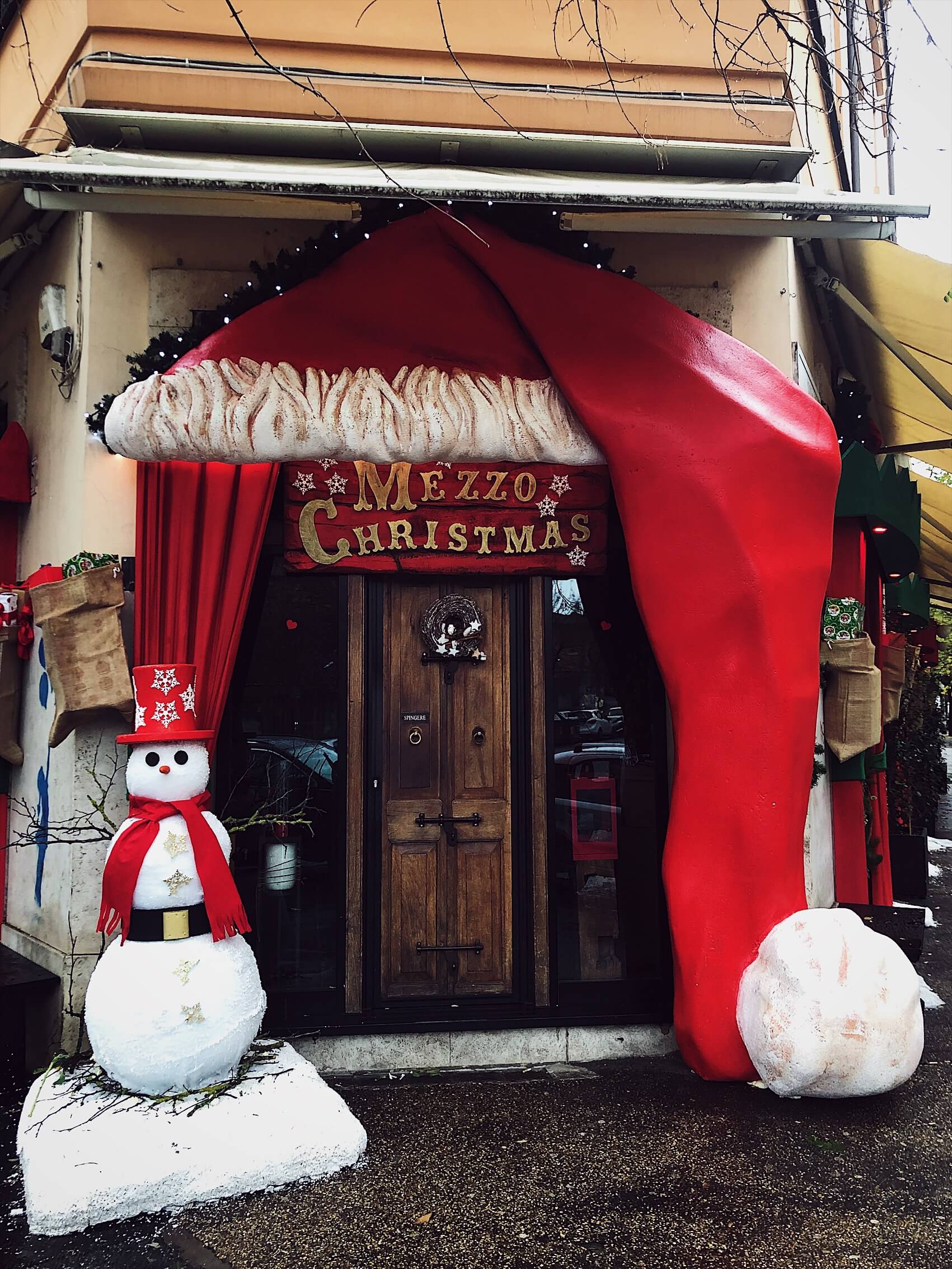 a Roman restaurant entrance decorated for Christmas