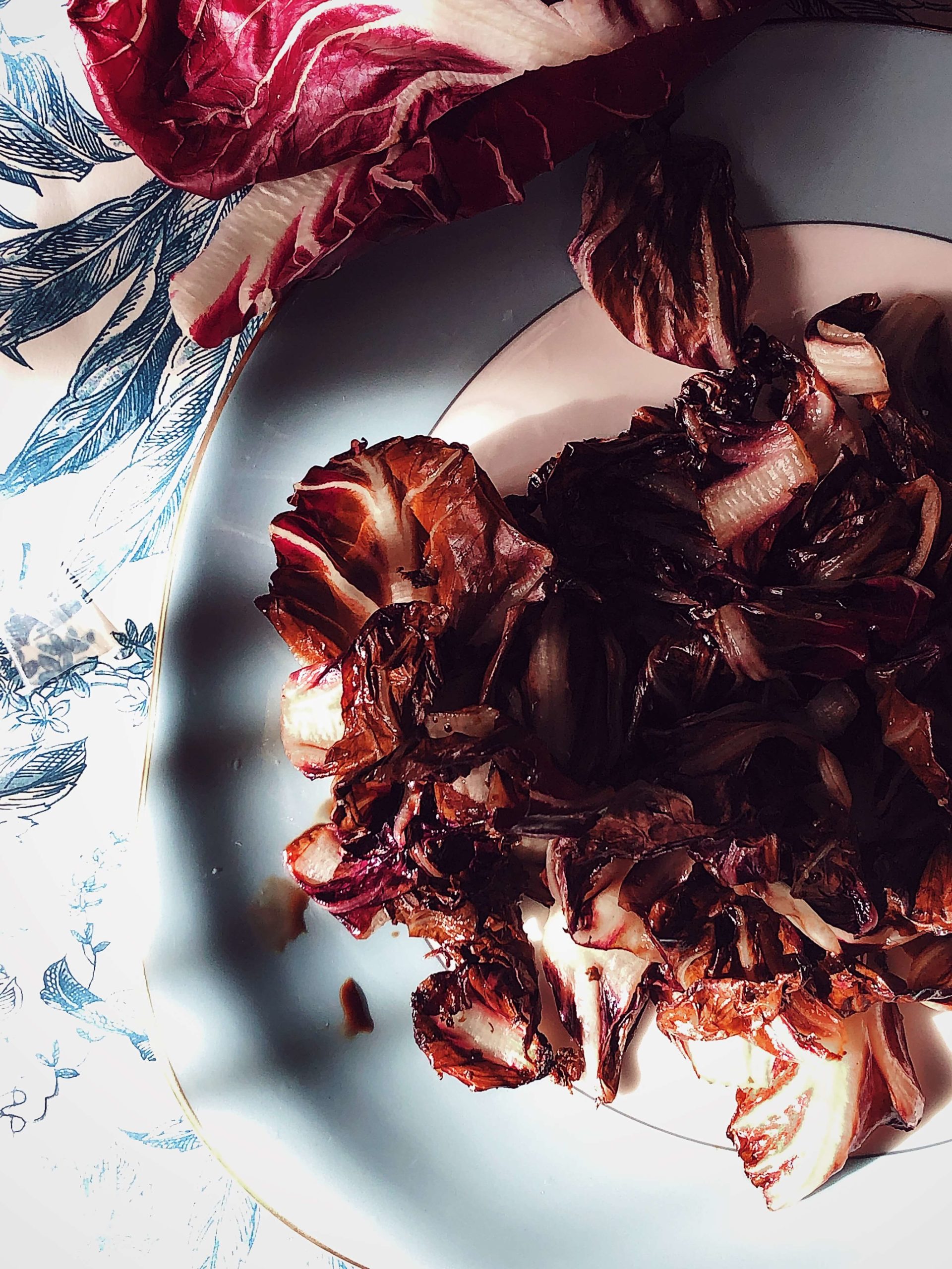grilled radicchio with balsamic vinegar on a blue plate