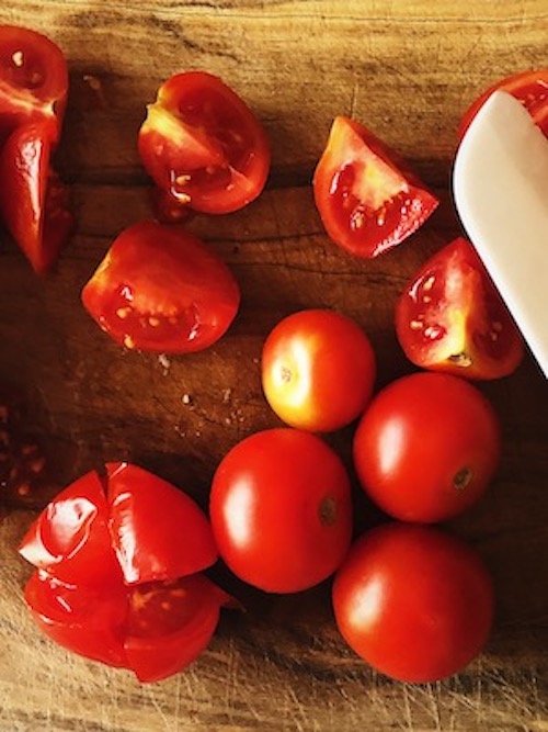 cut cherry tomatoes for the Italian eggplant sauce recipe