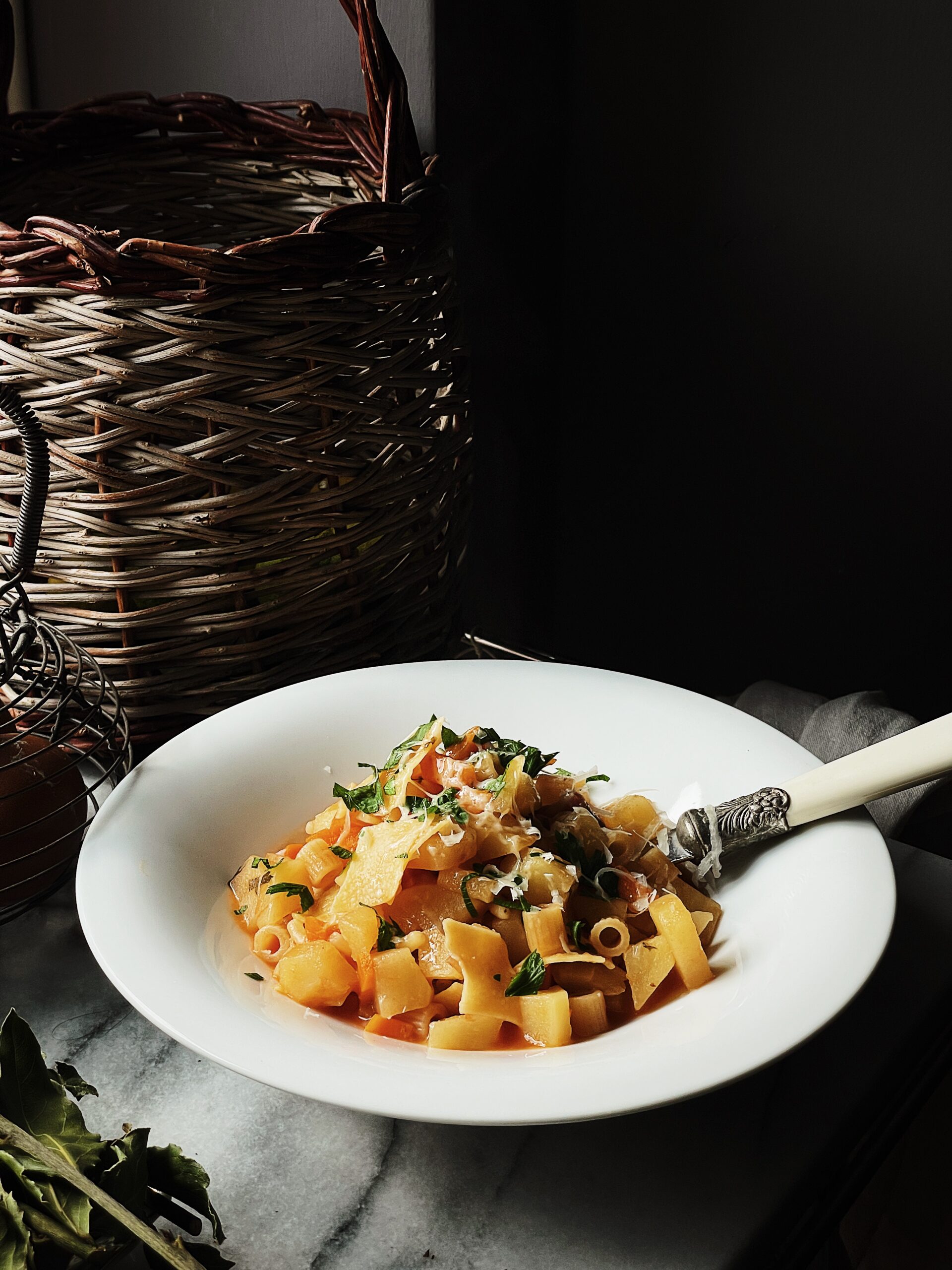 pasta e patate with provola cheese steaming in a terracotta bowl